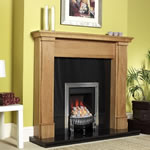 The Sherburn Mantel in Natural Oak with Black Granite back panel and hearth, featuring the Leanline 4 Gas Fire in Chrome with Pebbles, by Katell